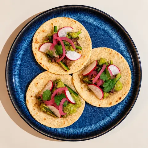 3 tacos on a blue plate